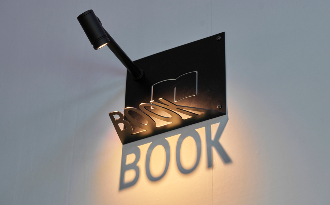 ライトと切り抜きパネルで描く壁面に浮かぶ影絵サイン